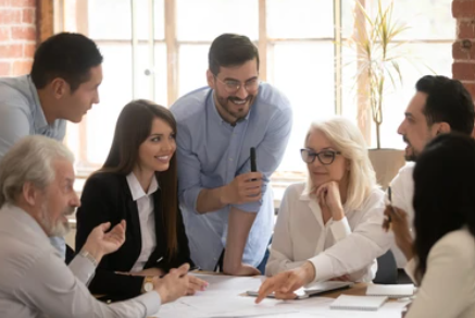 group of young professionals working together around a desk